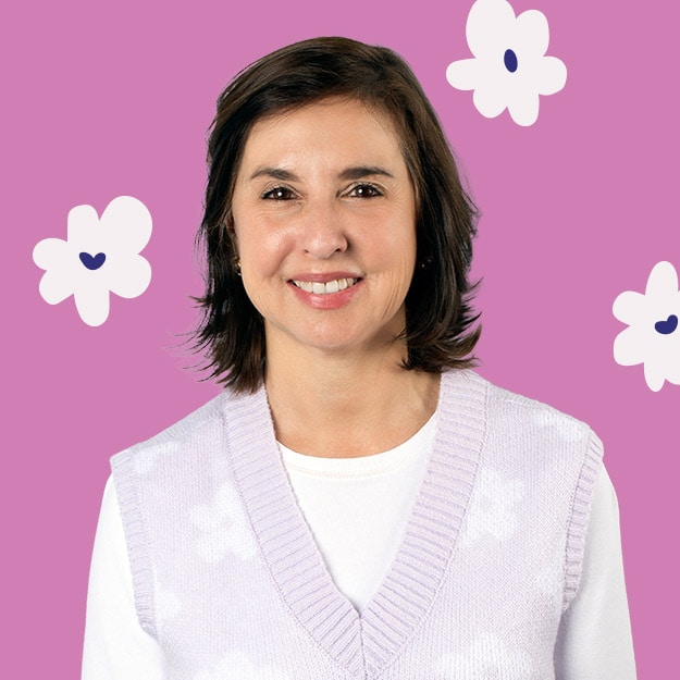 Portrait of a woman smiling against a magenta background with floral accents.