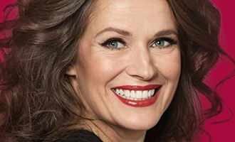 Smiling woman with voluminous brunette hair for hair care Valentine's gifts.