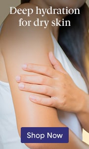 Person applying moisturizer or lotion to shoulder demonstrating dry skin hydration on neutral background with text 'Deeply hydrated skin' and 'Shop Now' button.