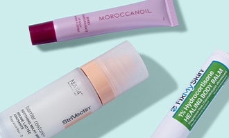 An assortment of summer skin care and beauty products arranged on a light background.