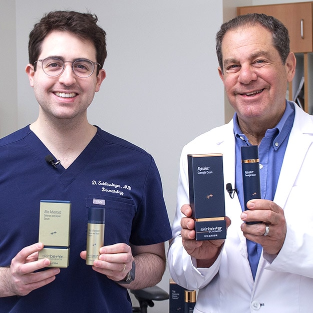 Dr. Joel & Daniel Schlessinger holding new skinbetter science products.
