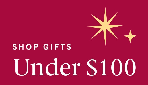 Shop gifts under $100 with gold star accents on burgundy background