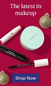 Latest makeup products including mascara and powder with gold ornaments on burgundy background