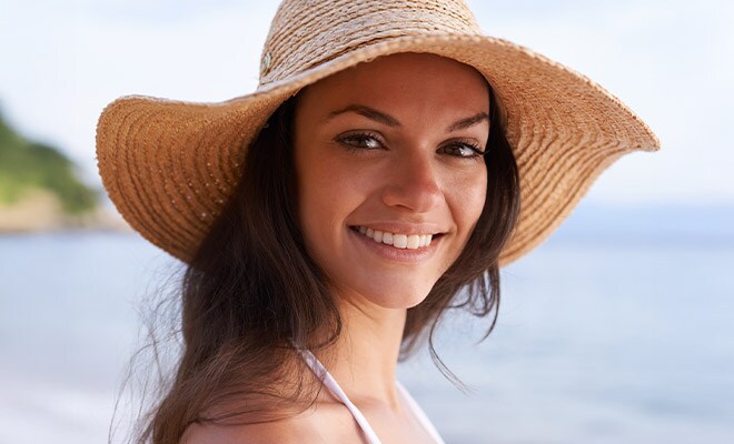 Young woman in a sun hat smiling