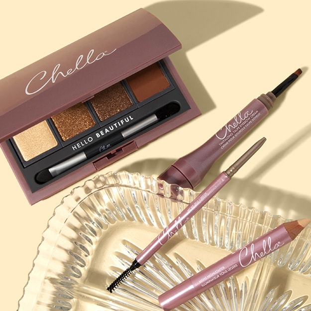 Open Chella brow palette with four warm gold, bronze and brown shades, alongside a Chella brow pen, brow pencil, highlighter pencil and spoolie.