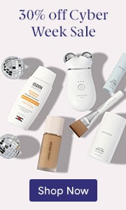 Makeup, sunscreen and skin care devices in a 30% off Cyber Week Sale arranged on a white background with two disco balls.