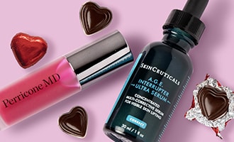 Gifts we're smitten with featuring lip gloss and hydrating serum with chocolate hearts on pink background.
