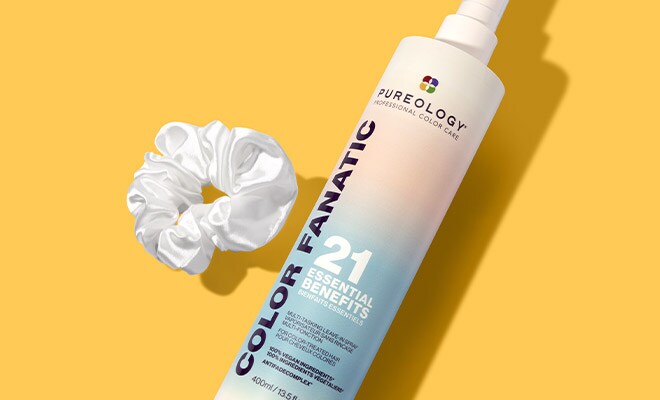 Container of Pureology Color Fanatic Leave-In Spray lying next to a scrunchy