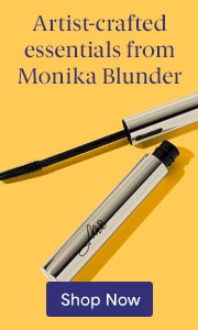 Silver mascara wand and tube from Monika Blunder cosmetics on a blue background with text 'Artist-crafted essentials from Monika Blunder' and 'Shop Now' button