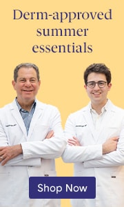 Drs. Joel and Daniel Schlessinger standing together, smiling with their arms crossed.