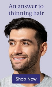 A man smiling and looking off into the distance