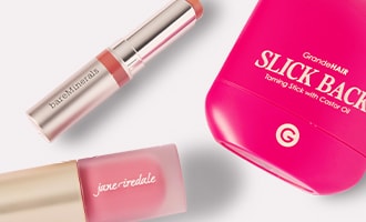 Loveable little gifts featuring lipstick, hair tool and lip plumper on pink background.