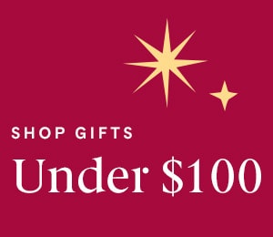 Shop gifts under $100 with gold star accents on burgundy background