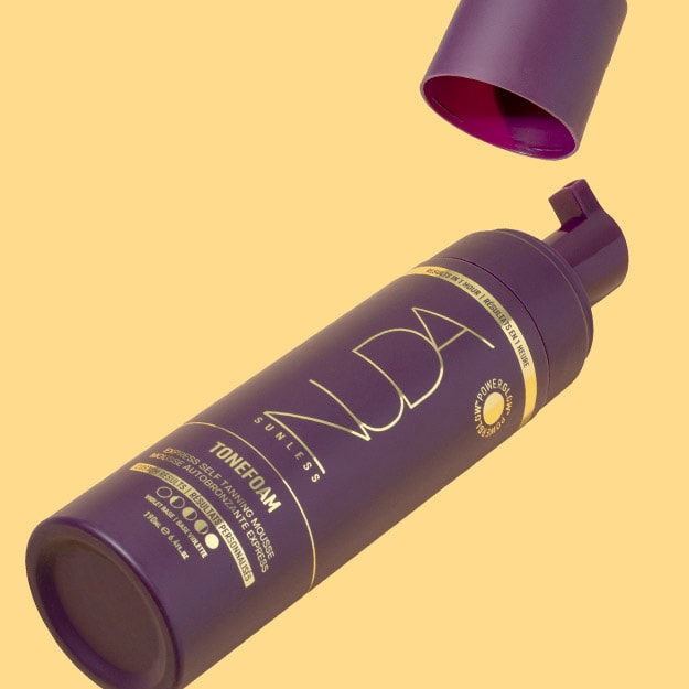 Yellow background featuring NUDA Sunless Tonefoam self-tanning mousse.
