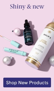 New hair care and skincare products on a pink background with holiday ornaments.