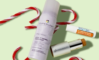 Pureology hair care products with candy cane striped ribbon on light green background