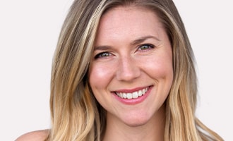 Smiling woman with smooth blonde hair.