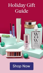 A collection of hair, makeup and skin care products in a Holiday Gift Guide sitting on turquoise blocks in front of a red background.